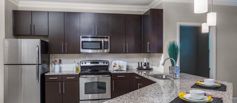 a kitchen with stainless steel appliances and granite counter tops