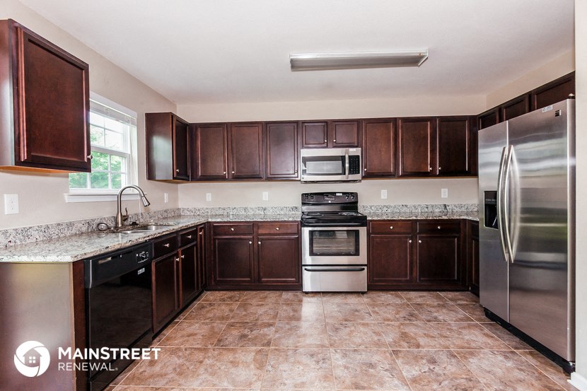 a kitchen with wooden cabinets and stainless steel appliances