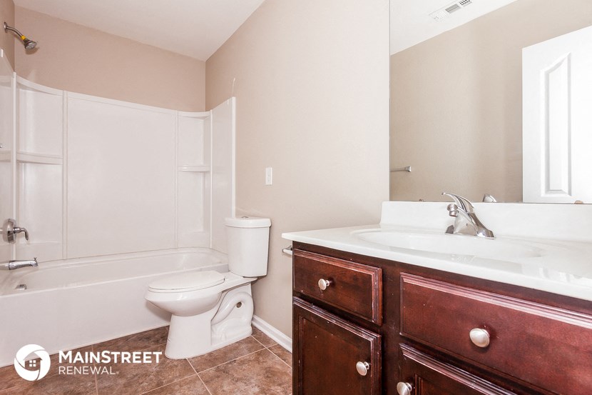 a bathroom with a sink toilet and a bath tub