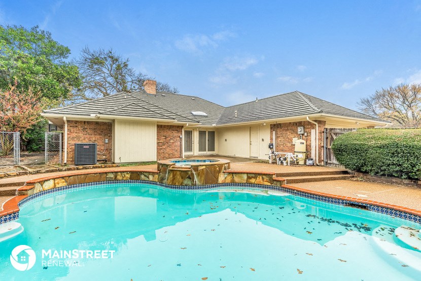 the pool and backyard of a house with a pool