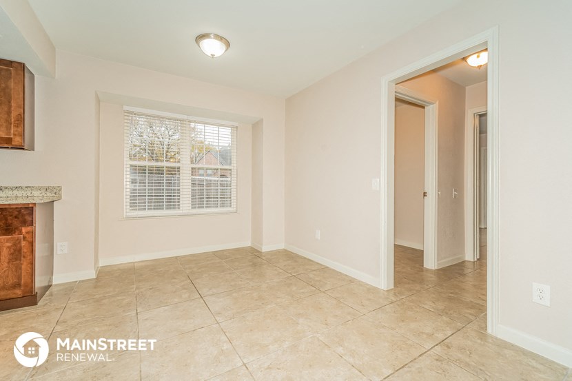 the living room and dining room are spacious with tile flooring and a fireplace