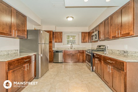 a kitchen with wooden cabinets and stainless steel appliances