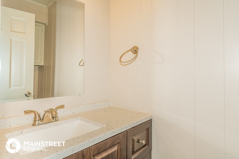 a small bathroom with a sink and a mirror