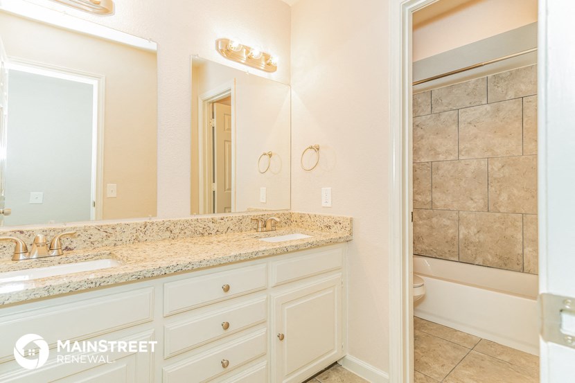 a bathroom with a sink and a mirror and a toilet
