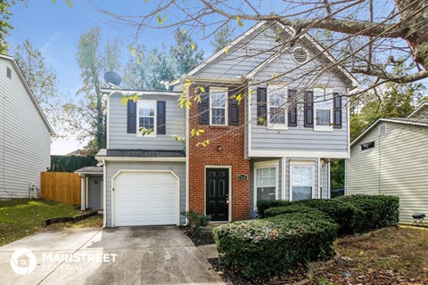 a brick and with a white garage door