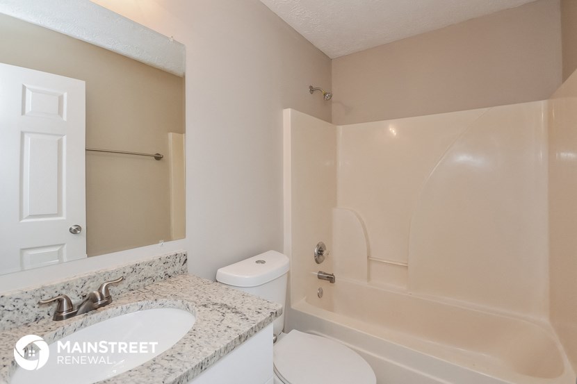 a bathroom with a sink and a toilet and a bath tub