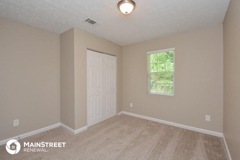 the interior of an empty room with a door and a window