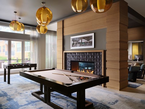 a pool table in a living room with a fireplace