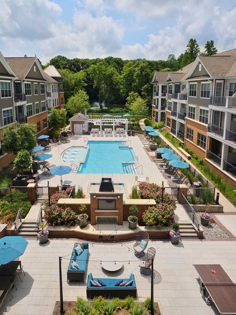an aerial view of an apartment complex with a swimming pool