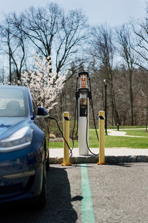 a car parked at a charging station at a gas pump