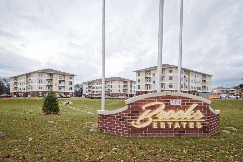a sign for the bricks estates in front of an apartment building