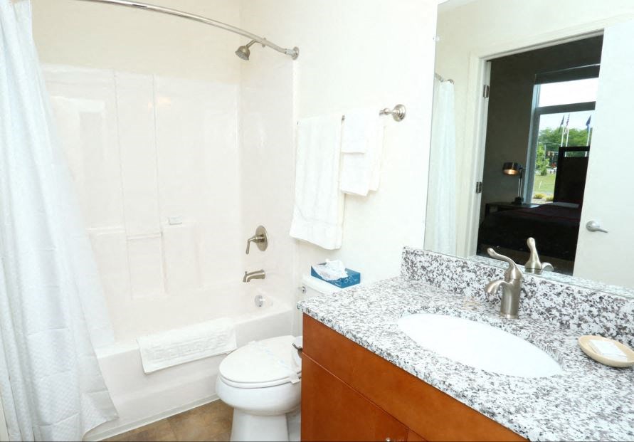 a bathroom with a sink and a toilet and a shower