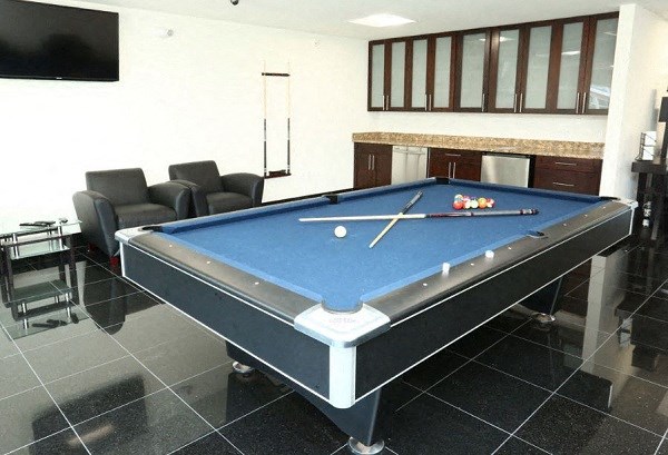 a pool table in a living room with a tv