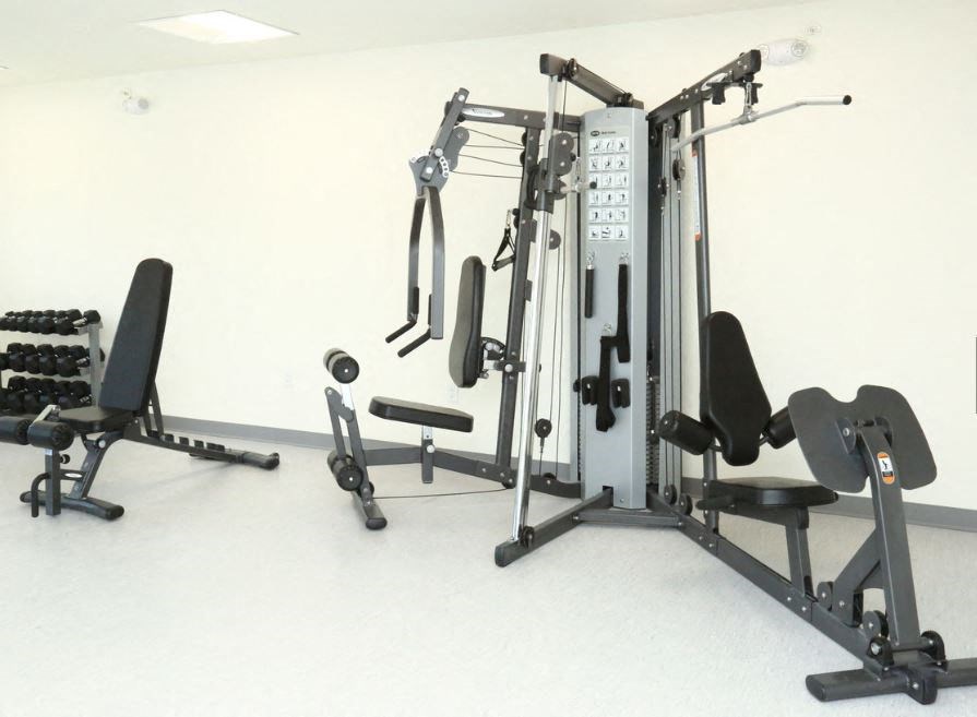 a gym with weights and other equipment in a room