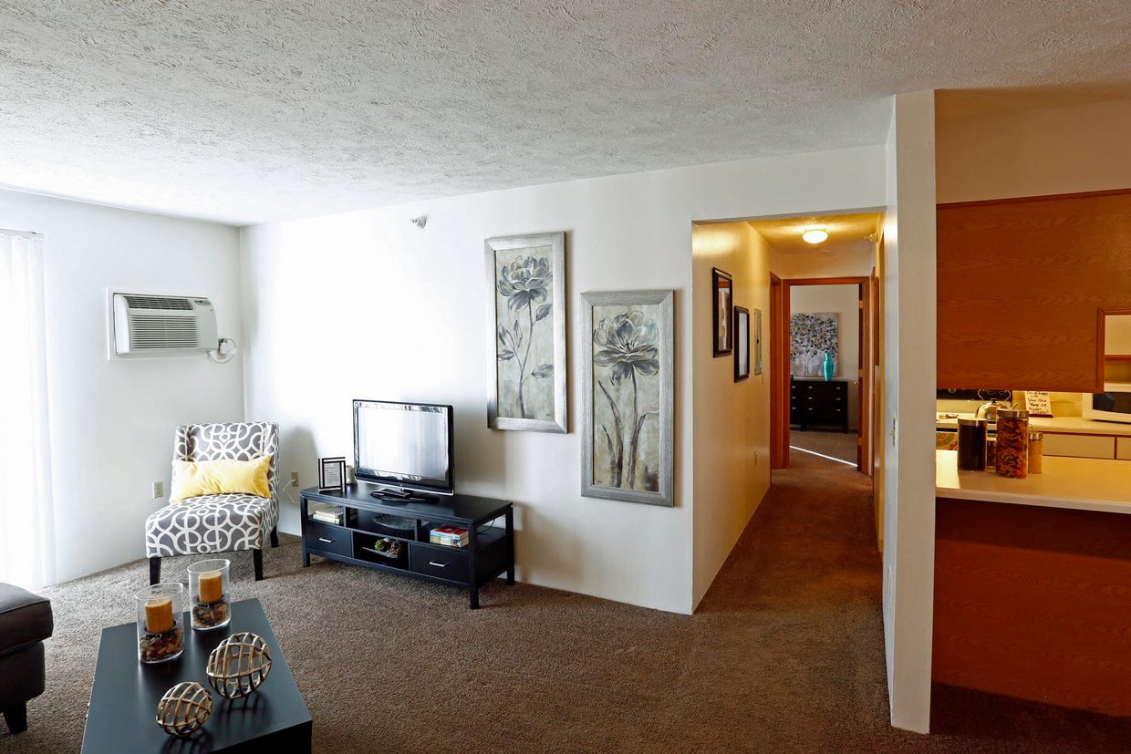A living room with a television and a chair.
