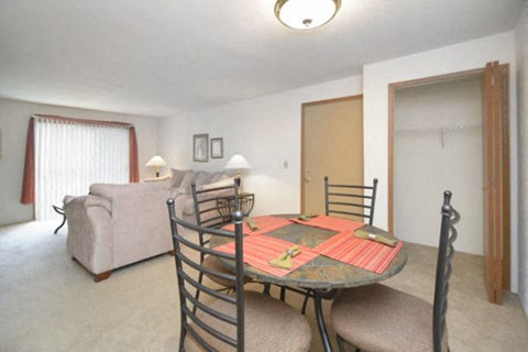 a living room with a dining room table and a couch