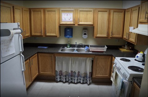 A kitchen with wooden cabinets and a white refrigerator.