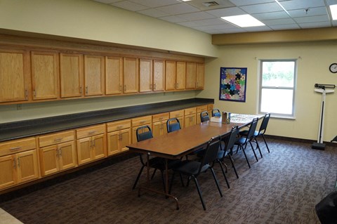 A conference room with a long table and chairs.