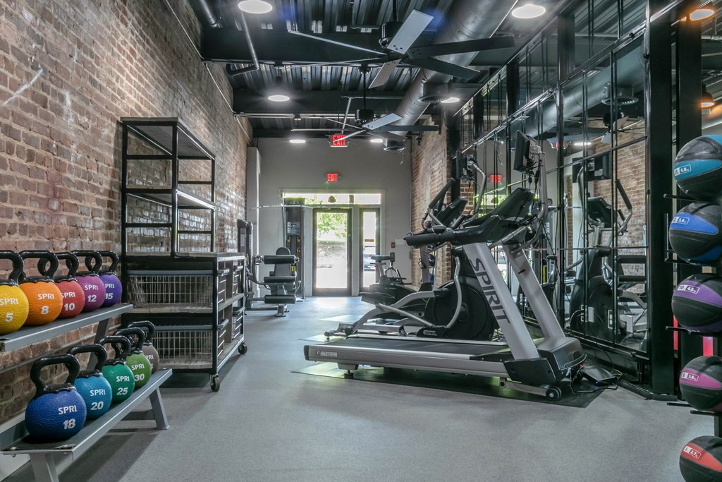 a gym with weights and a row of weights on a rack