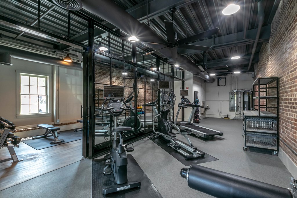 the gym with weights and other equipment at the apartments