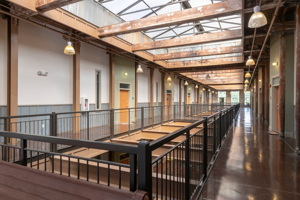 a long hallway with benches and a glass ceiling
