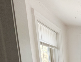 an empty room with wooden floors and three windows