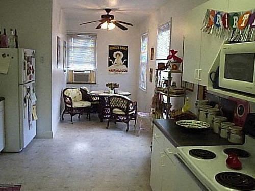 a kitchen with a stove and a dining room