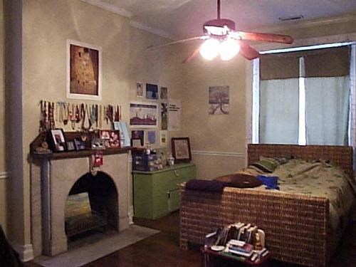 a living room with a fireplace and a bed