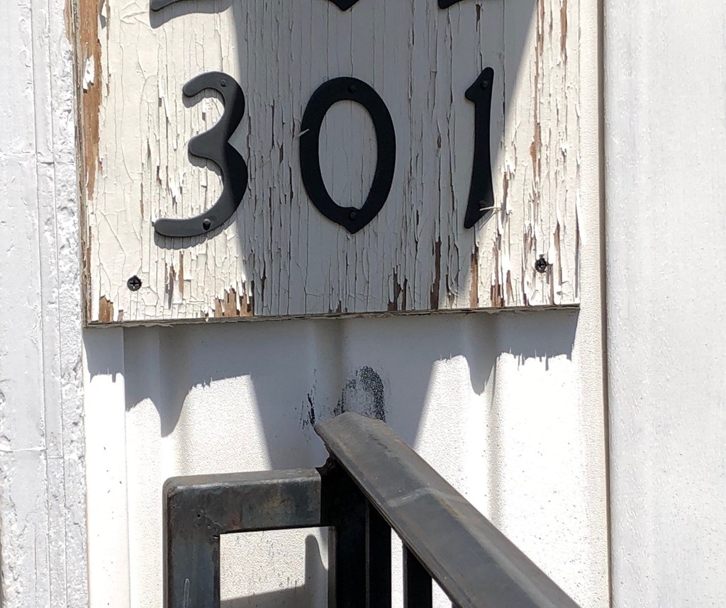 a sign on the side of a building with the number 300 on it