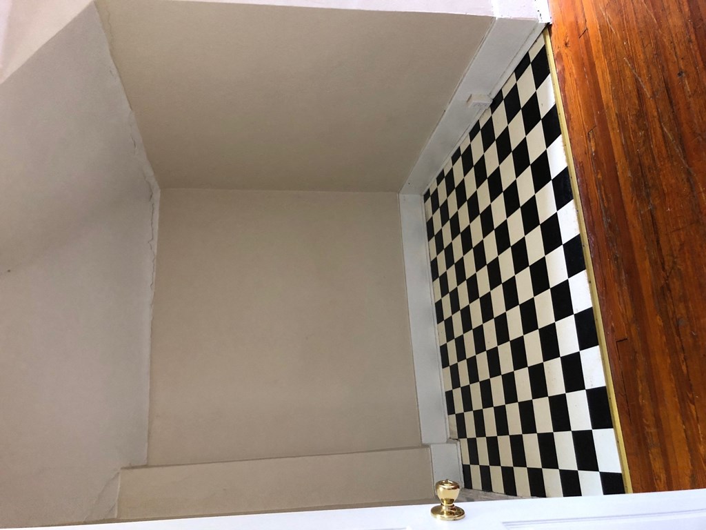a bathroom with a black and white checkered wall