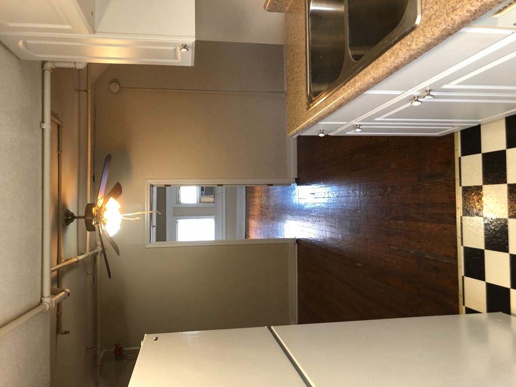 a small kitchen with a counter top and a window