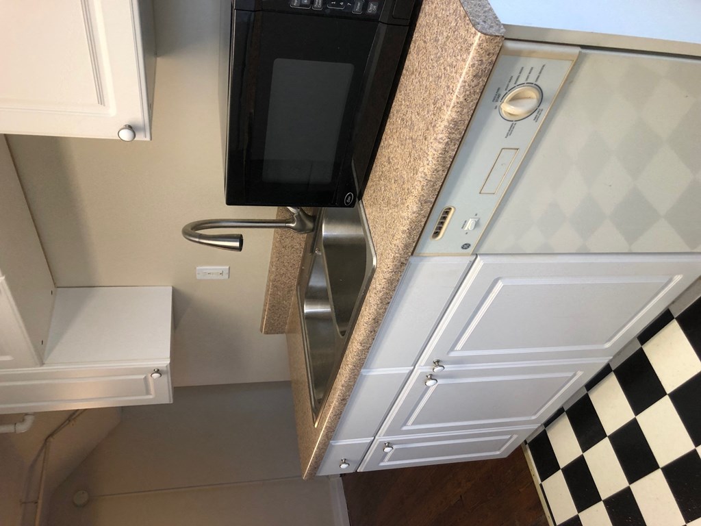 a kitchen with a sink and a microwave in it