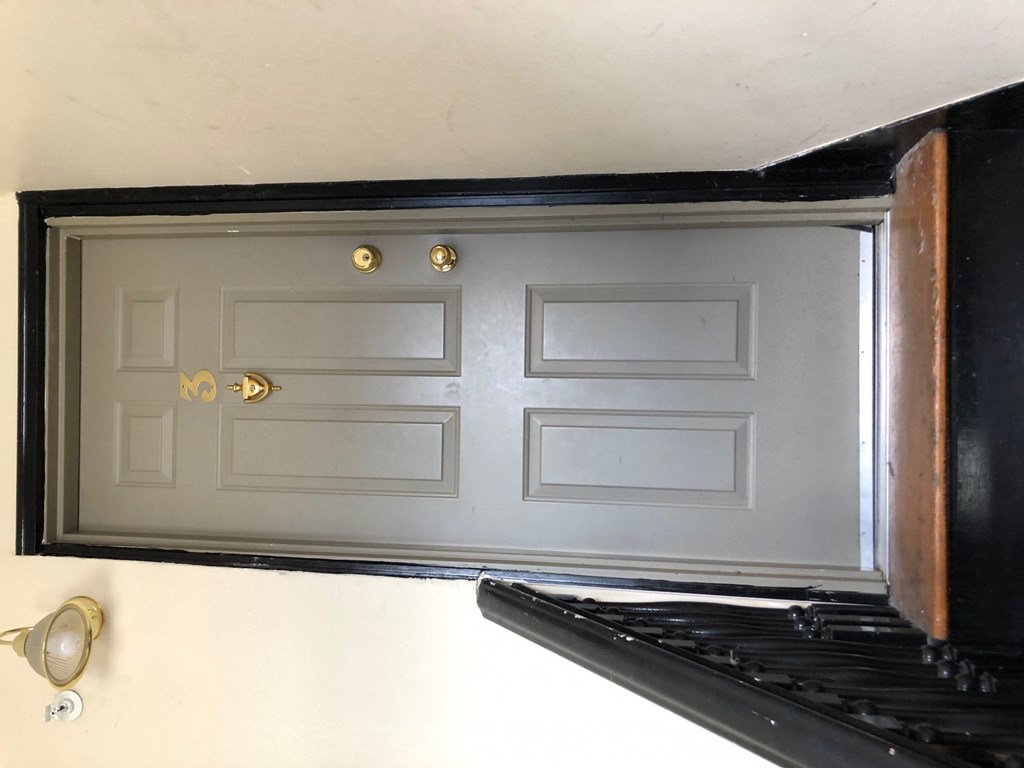 an old kitchen window with white doors and a stove