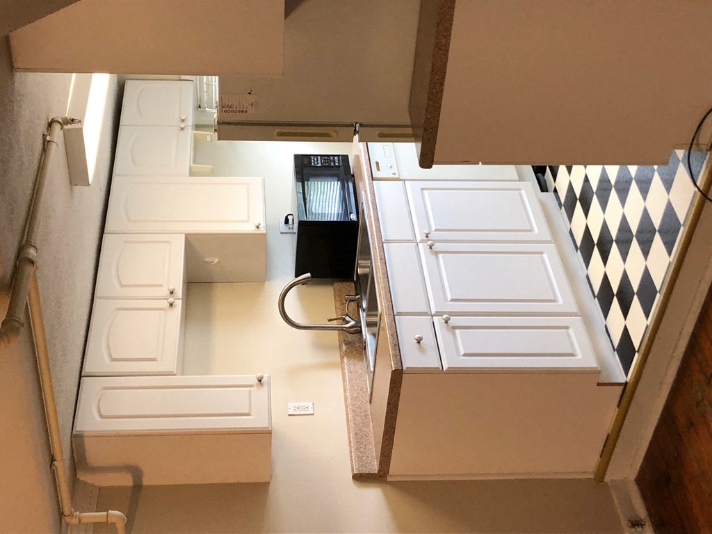 a kitchen with a stove and a sink in it