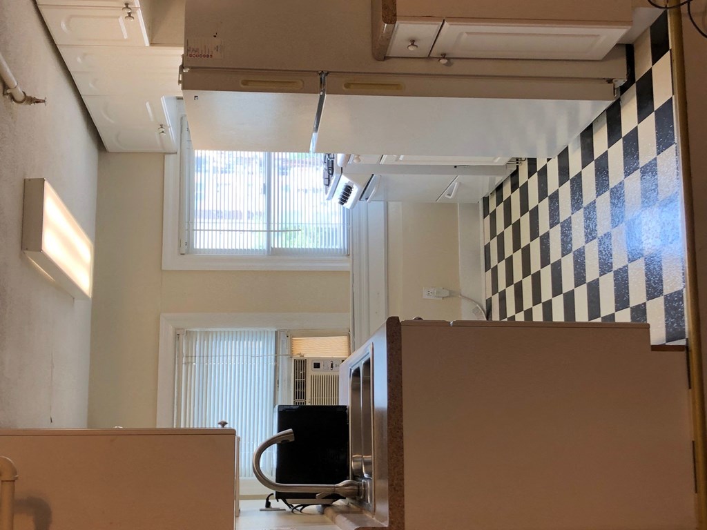 a room with a desk and a chair and a checkered wall