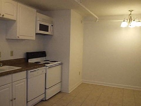 a small kitchen with a stove and a microwave