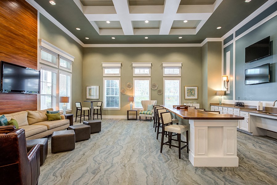 a large living room with a bar and a television