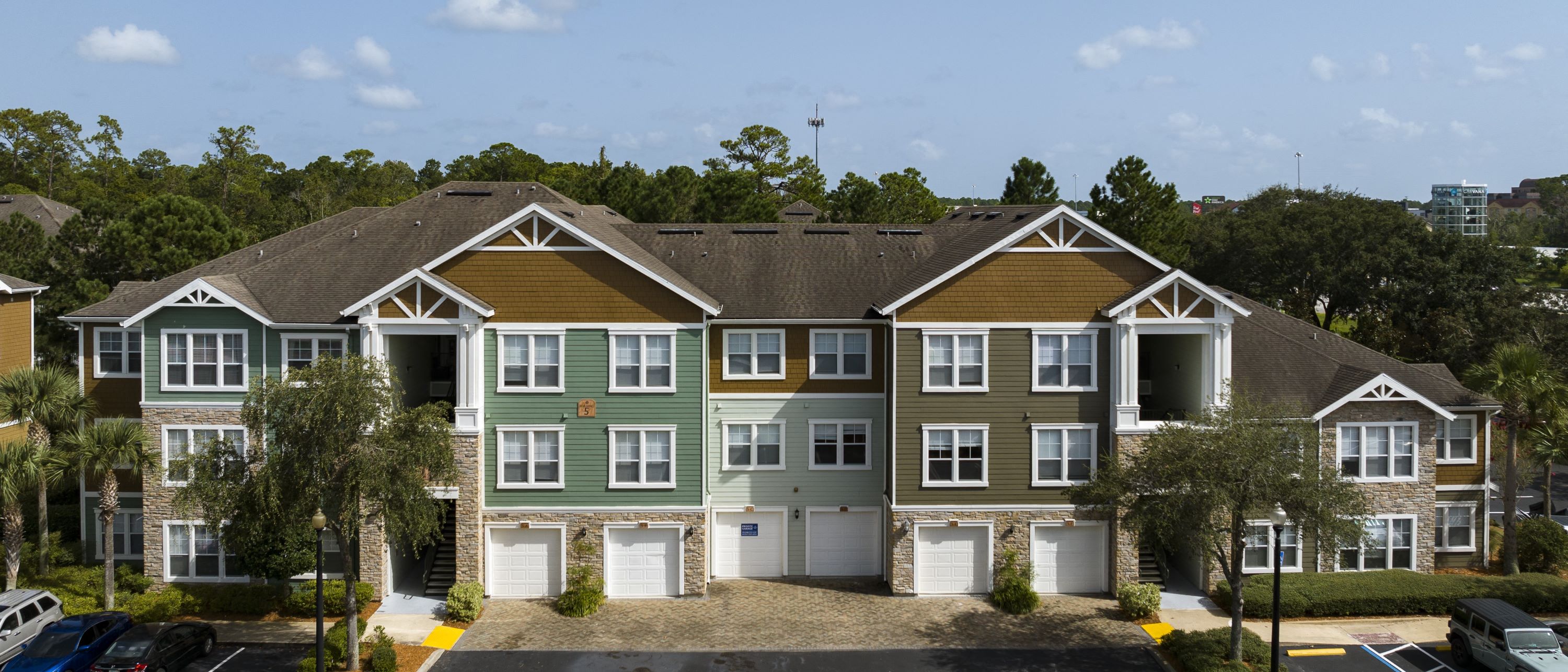 an aerial view of an apartment building with a parking lot