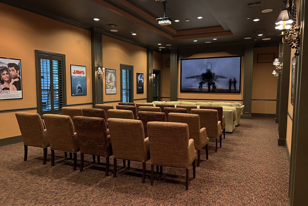 a conference room with rows of chairs and a projector screen