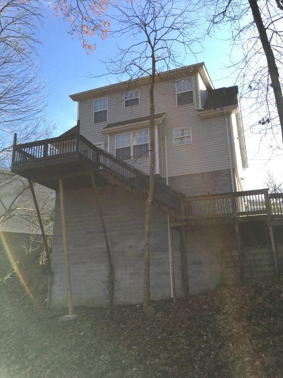 a house with a balcony on top of a hill