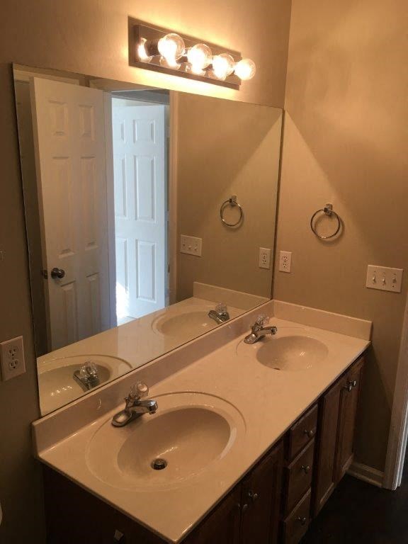a bathroom with two sinks and a mirror