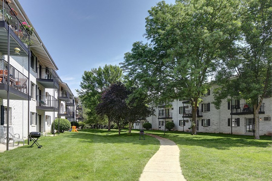 the view of a yard between two apartment buildings