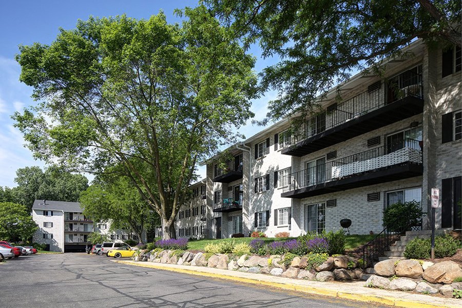 a row of apartment buildings on the side of a street