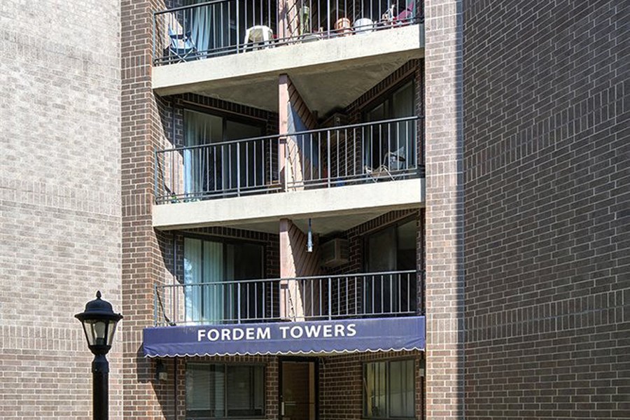 a tall brick building with a blue sign