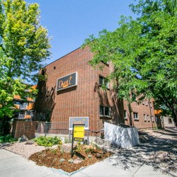 a brick building with a sign on the side of it