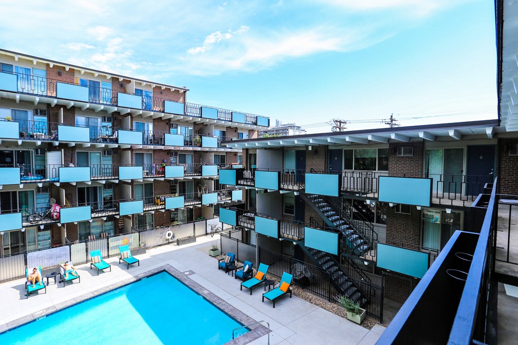an overhead view of an apartment building with a swimming pool