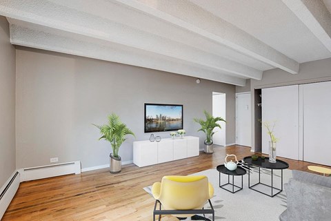 a living room with a couch and a tv on the wall