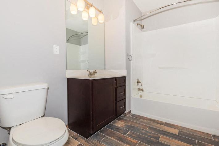 a bathroom with a toilet and a tub and a sink