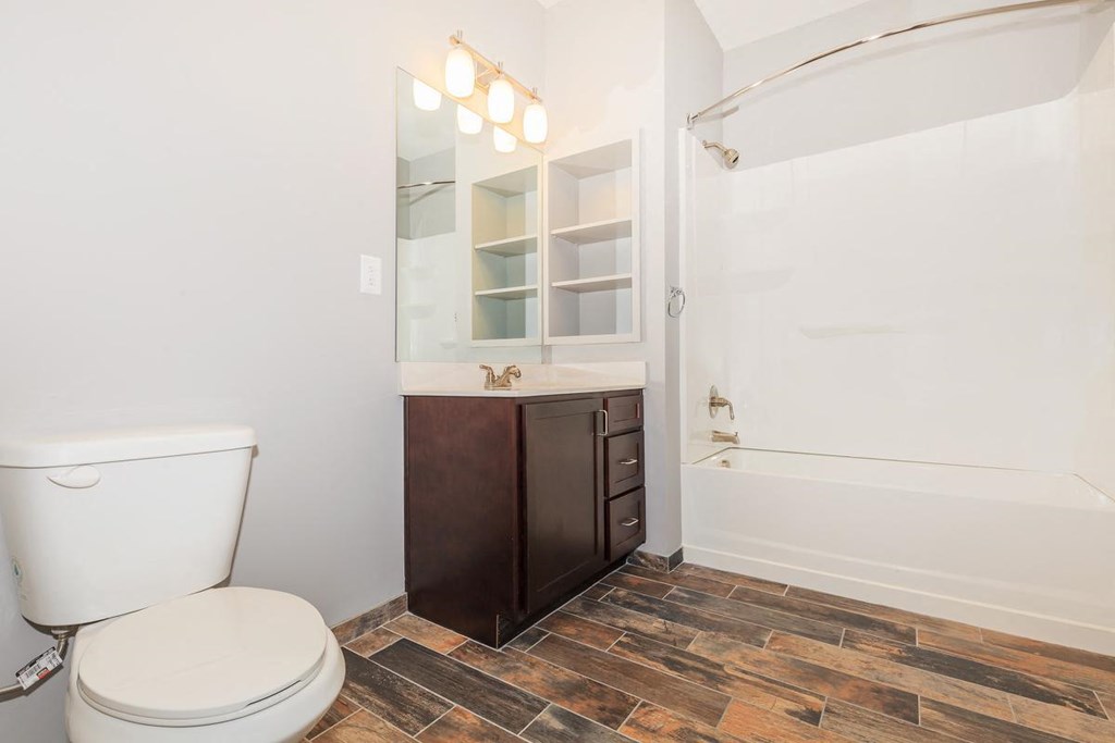 a bathroom with a toilet and a tub and a sink