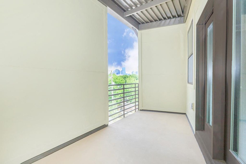a room with a view of a balcony and a door